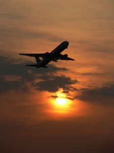 Plane taking off at sunset